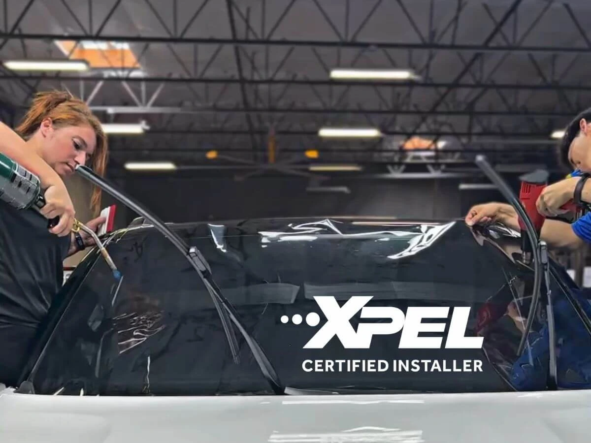 Technicians installing XPEL ceramic window tint on a vehicle at Clear Cut Glass and Tint in Glendale, Arizona, showcasing professional heat-shrinking and precision fit.