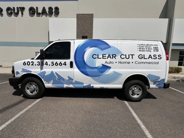 Clear Cut Glass Service Van – Auto, Home & Commercial Glass in Glendale AZ Clear Cut Glass service van parked outside the Glendale AZ shop, showcasing auto, home, and commercial glass services with company branding and contact number.