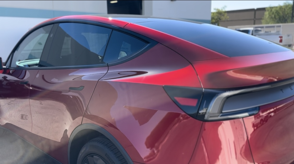 Tesla Model Y Ceramic Coating – Clear Cut Glass and Tint Glendale AZ Red Tesla Model Y with fresh ceramic coating applied at Clear Cut Glass and Tint in Glendale Arizona, showing high-gloss paint protection and enhanced finish.