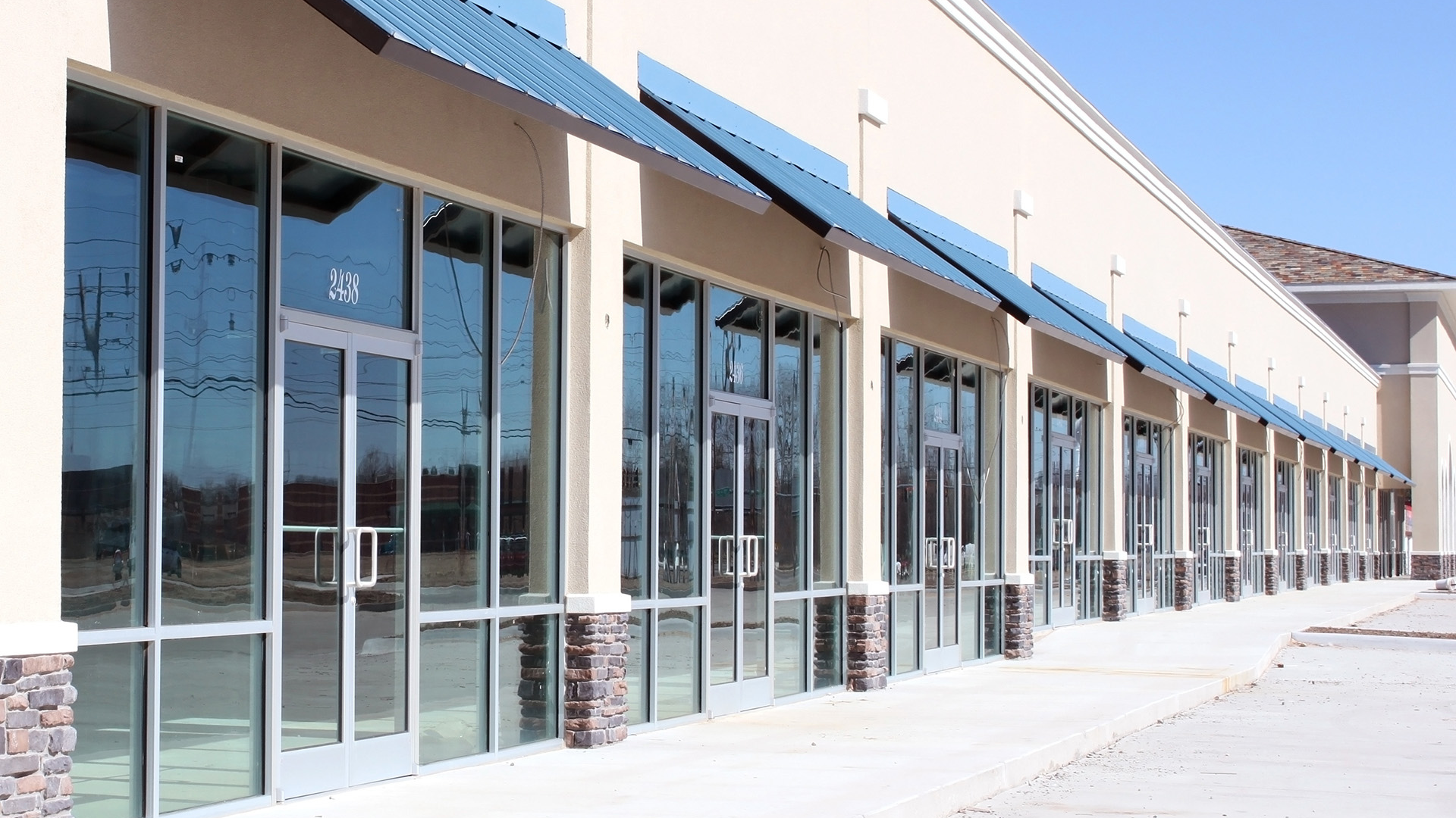 Commercial storefront glass windows and aluminum doors installed for retail suites by Clear Cut Glass and Tint in Arizona