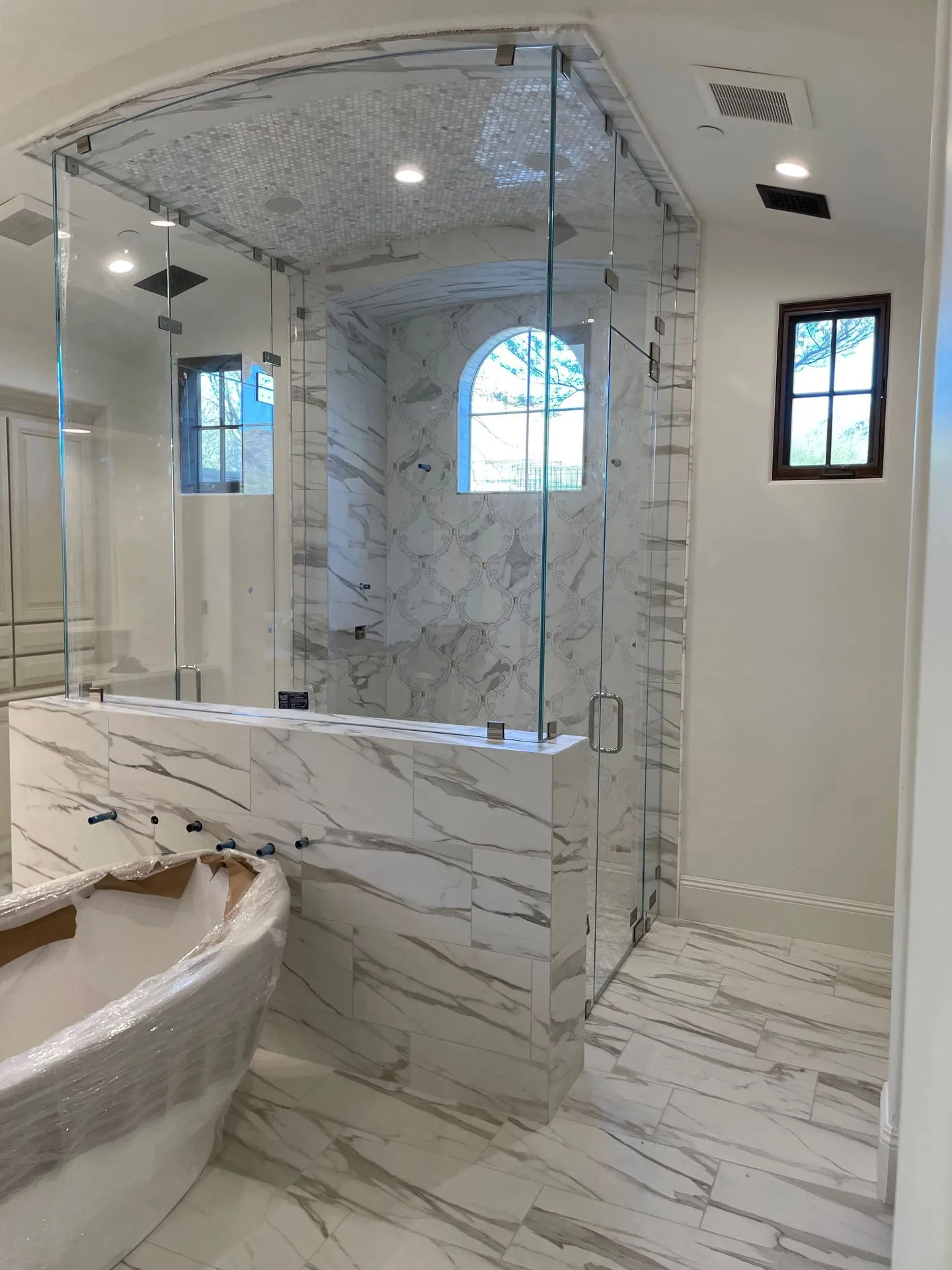 Custom Double Glass Shower Enclosure with Arched Design | Clear Cut Glass and Tint Custom double glass shower enclosure with arched ceiling, marble tile, and frameless glass panels in a luxury Arizona bathroom, installed by Clear Cut Glass and Tint