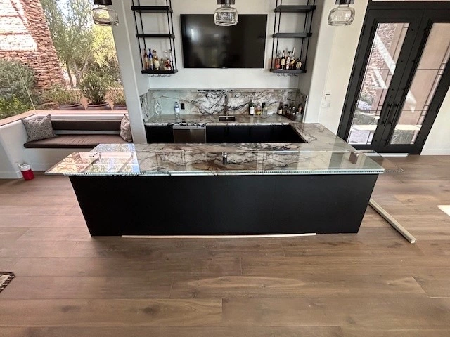 Custom Glass Bar Top Countertop Overlay – Alternate View | Clear Cut Glass and Tint Alternate angle of a custom glass bar top countertop overlay installed over stone in a modern Arizona home, by Clear Cut Glass and Tint
