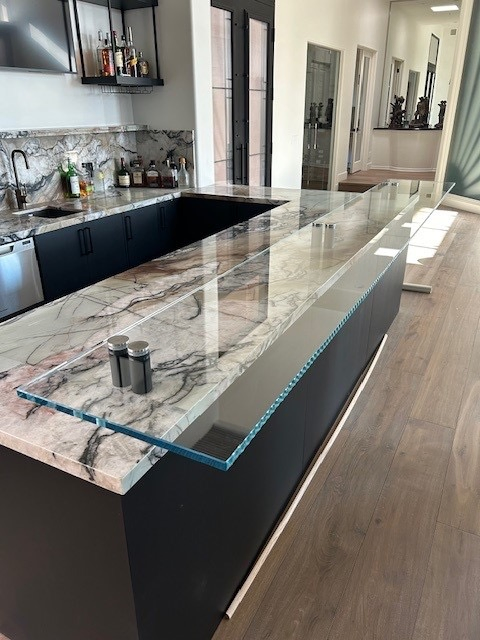 Custom Glass Bar Top Countertop Overlay | Clear Cut Glass and Tint Custom glass bar top countertop overlay installed over stone surface in a modern Arizona home, created by Clear Cut Glass and Tint