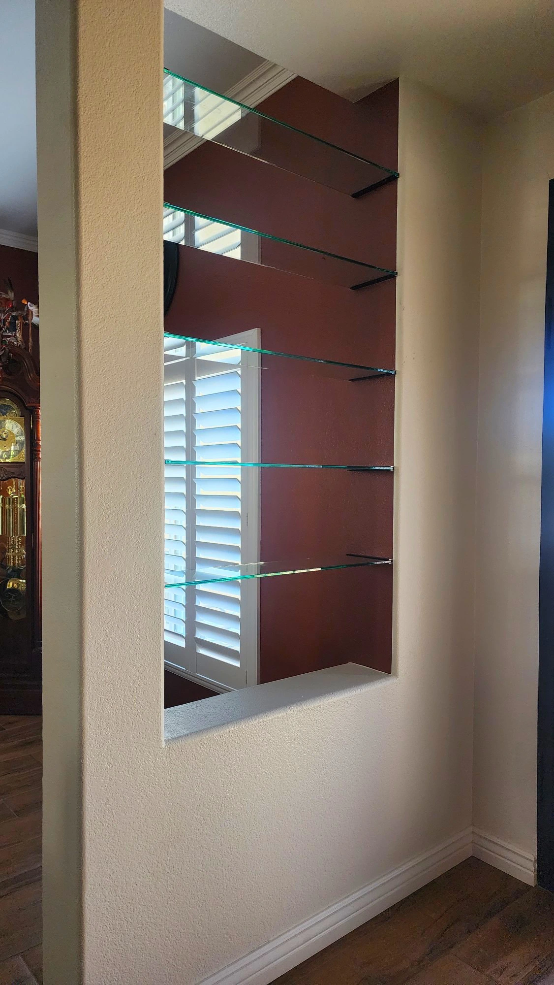 Custom Interior Glass Shelving Installation | Clear Cut Glass and Tint Custom glass shelving installed in a recessed wall niche inside an Arizona home, designed and installed by Clear Cut Glass and Tint