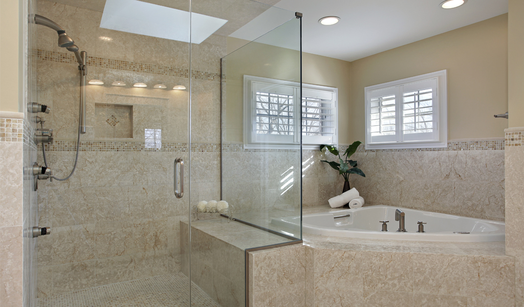 Custom Glass Shower and Tub Enclosure | Clear Cut Glass and Tint Custom glass shower enclosure with adjacent soaking tub and tile surround in a luxury Arizona bathroom, installed by Clear Cut Glass and Tint