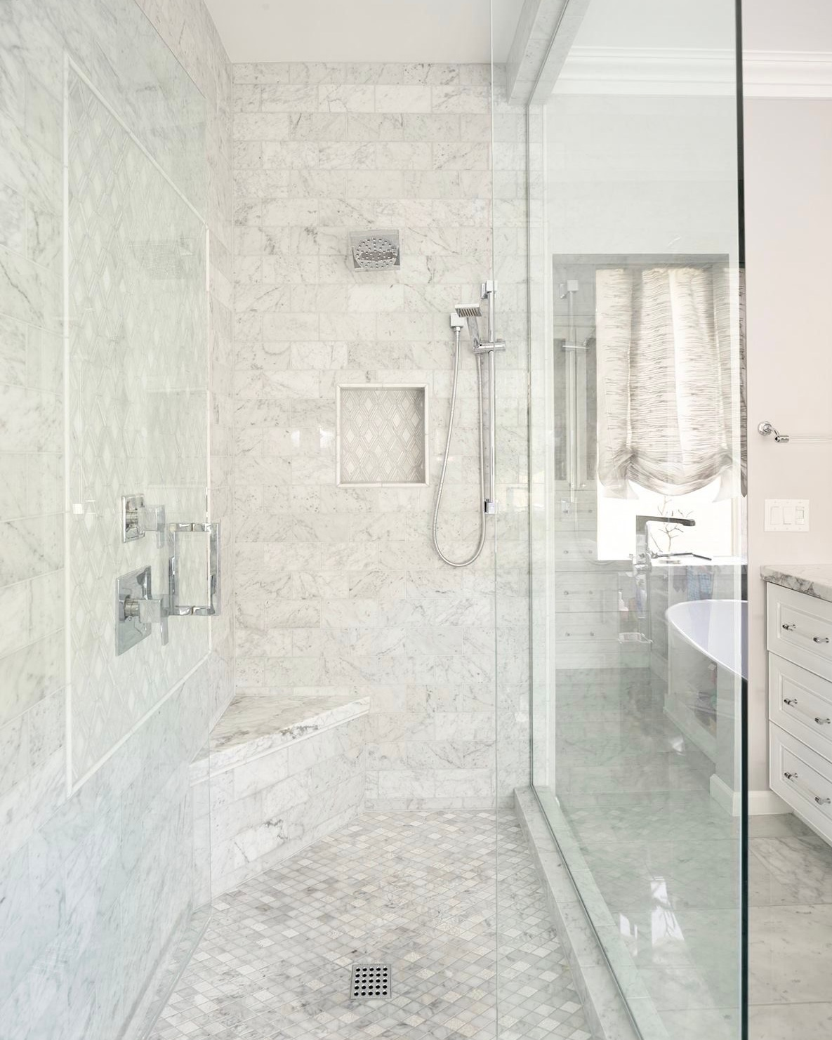 Frameless Custom Glass Shower Installation | Clear Cut Glass and Tint Frameless custom glass shower with marble tile, built-in bench, and modern fixtures in a luxury Arizona bathroom, installed by Clear Cut Glass and Tint