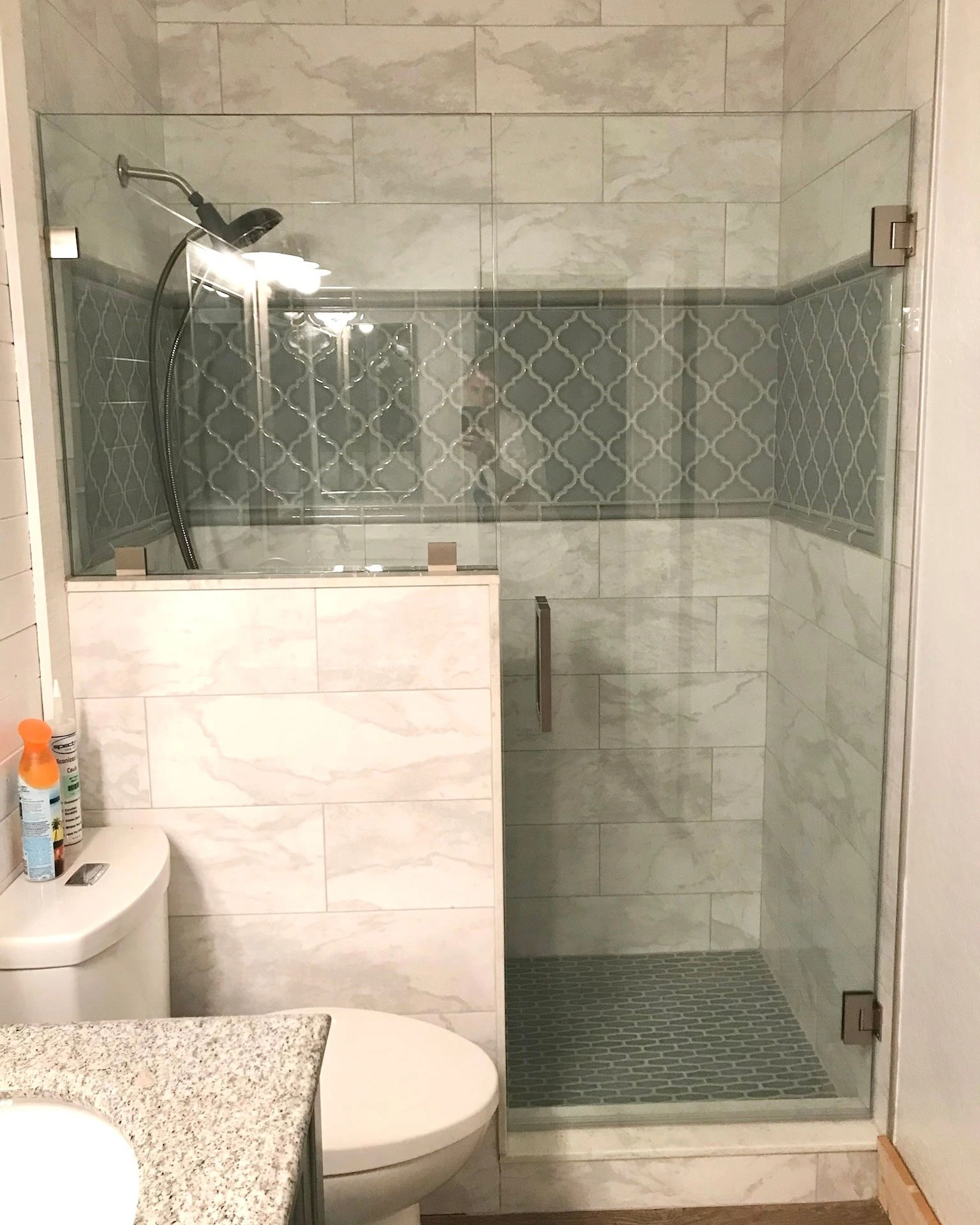 Frameless Glass Shower with Patterned Tile | Clear Cut Glass and Tint Frameless glass shower enclosure with patterned accent tile and half-wall design in an Arizona home bathroom, installed by Clear Cut Glass and Tint