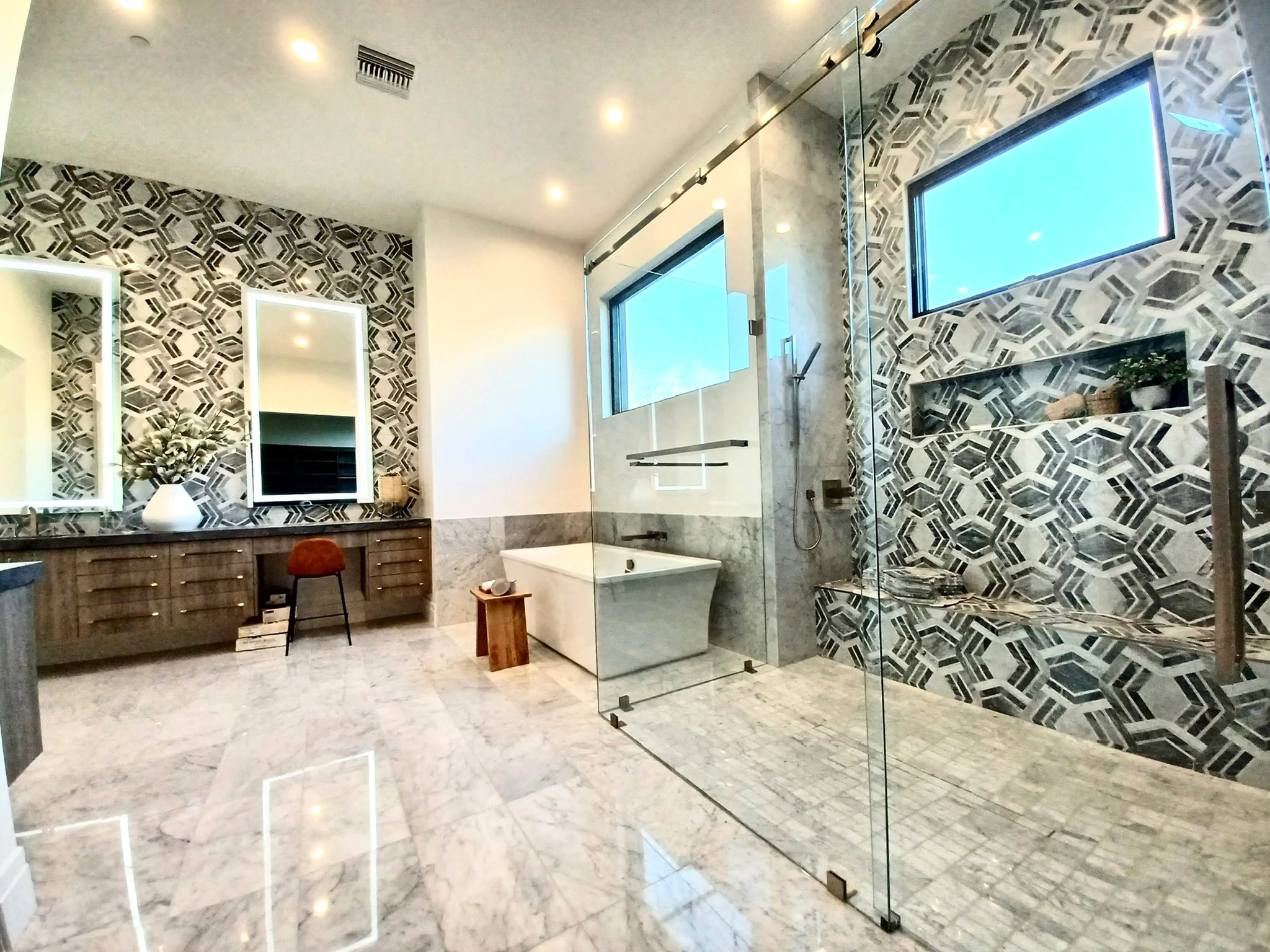 Luxury bathroom featuring a frameless glass shower enclosure and custom wall mirrors installed by Clear Cut Glass and Tint in an Arizona home