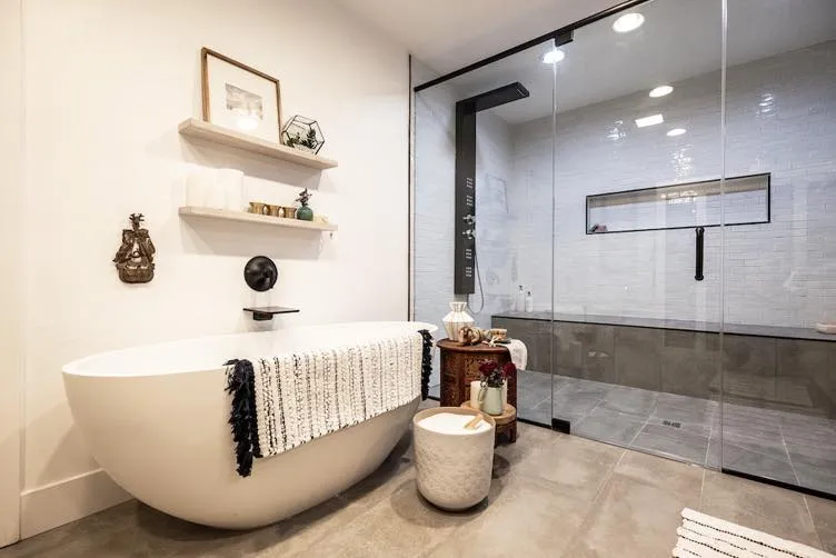 Modern Glass Shower Wall Installation | Clear Cut Glass and Tint Modern bathroom featuring a full glass shower wall, freestanding soaking tub, and minimalist design, installed by Clear Cut Glass and Tint in an Arizona home