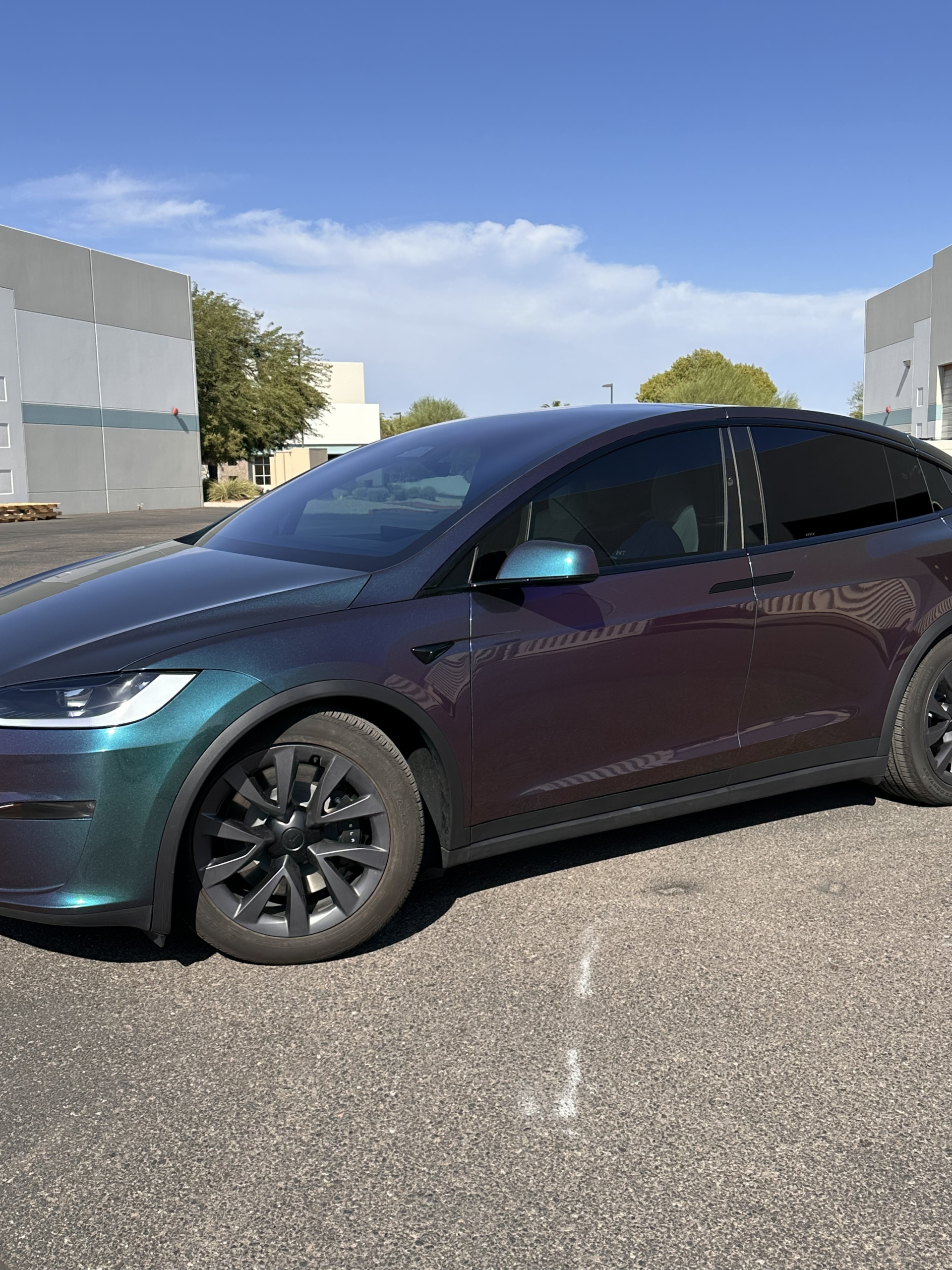 Tesla Model X wrapped in green-to-purple chameleon color paint protection film, photographed outside Clear Cut Glass and Tint in Glendale, Arizona