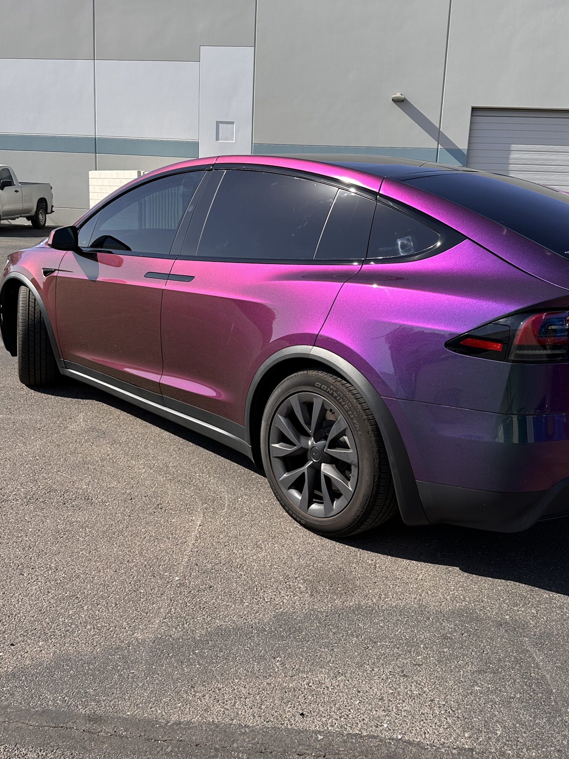 Tesla Model X wrapped in purple iridescent color paint protection film, parked at Clear Cut Glass in Glendale, Arizona