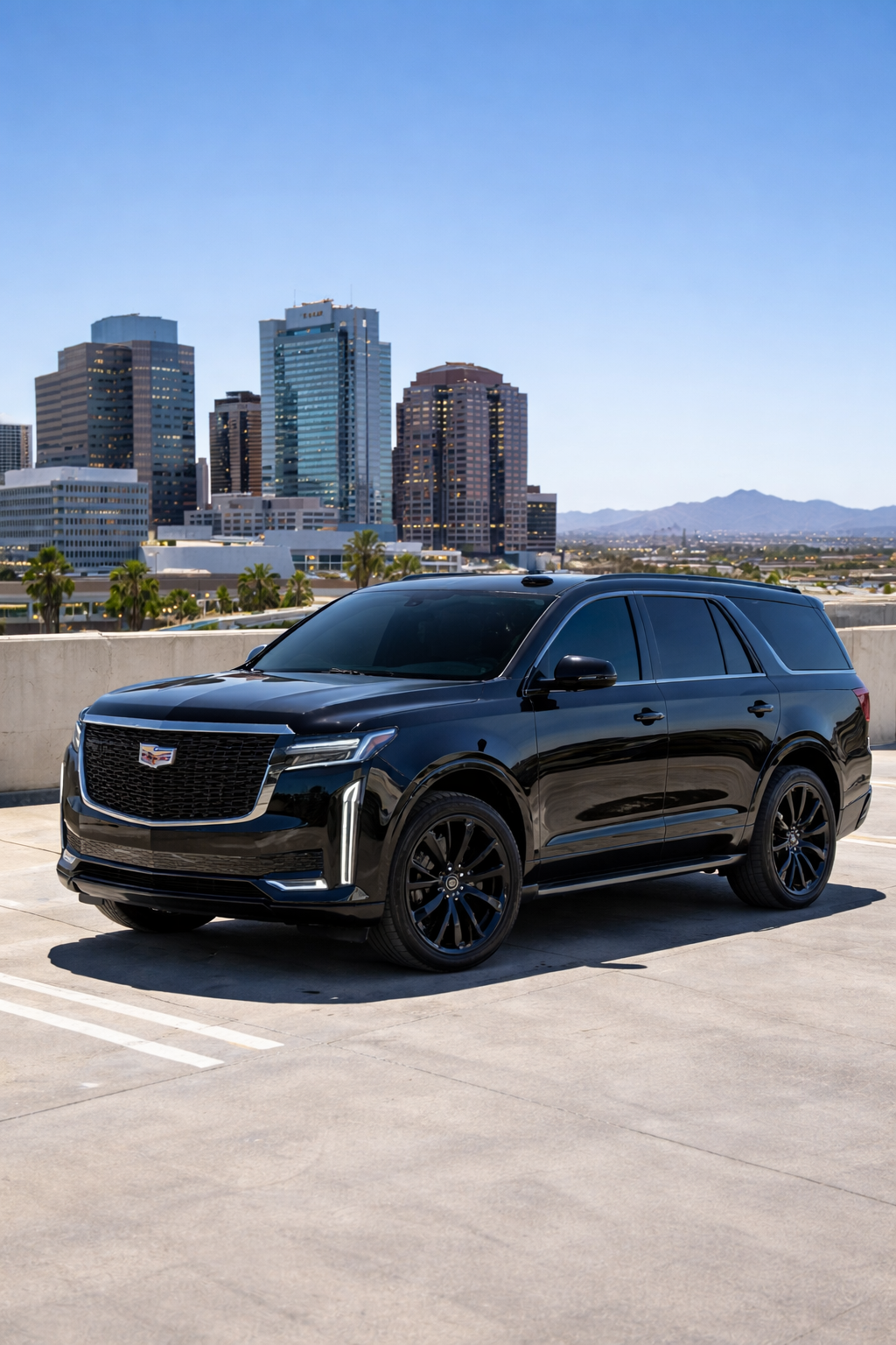 Cadillac Escalade with premium window tint parked on a downtown Phoenix rooftop in bright midday sun