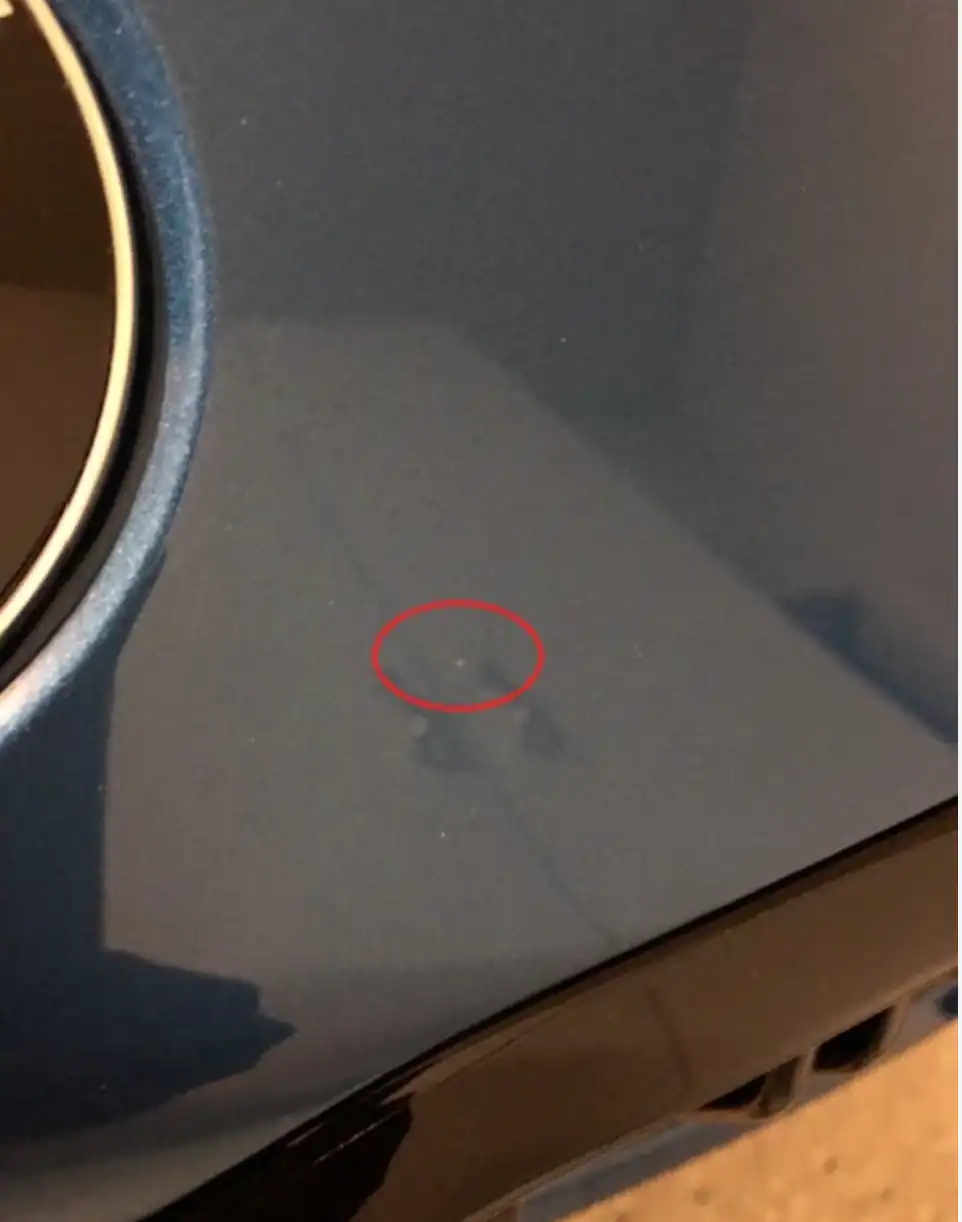 Dust and debris trapped under paint protection film causing visible contamination due to poor installation