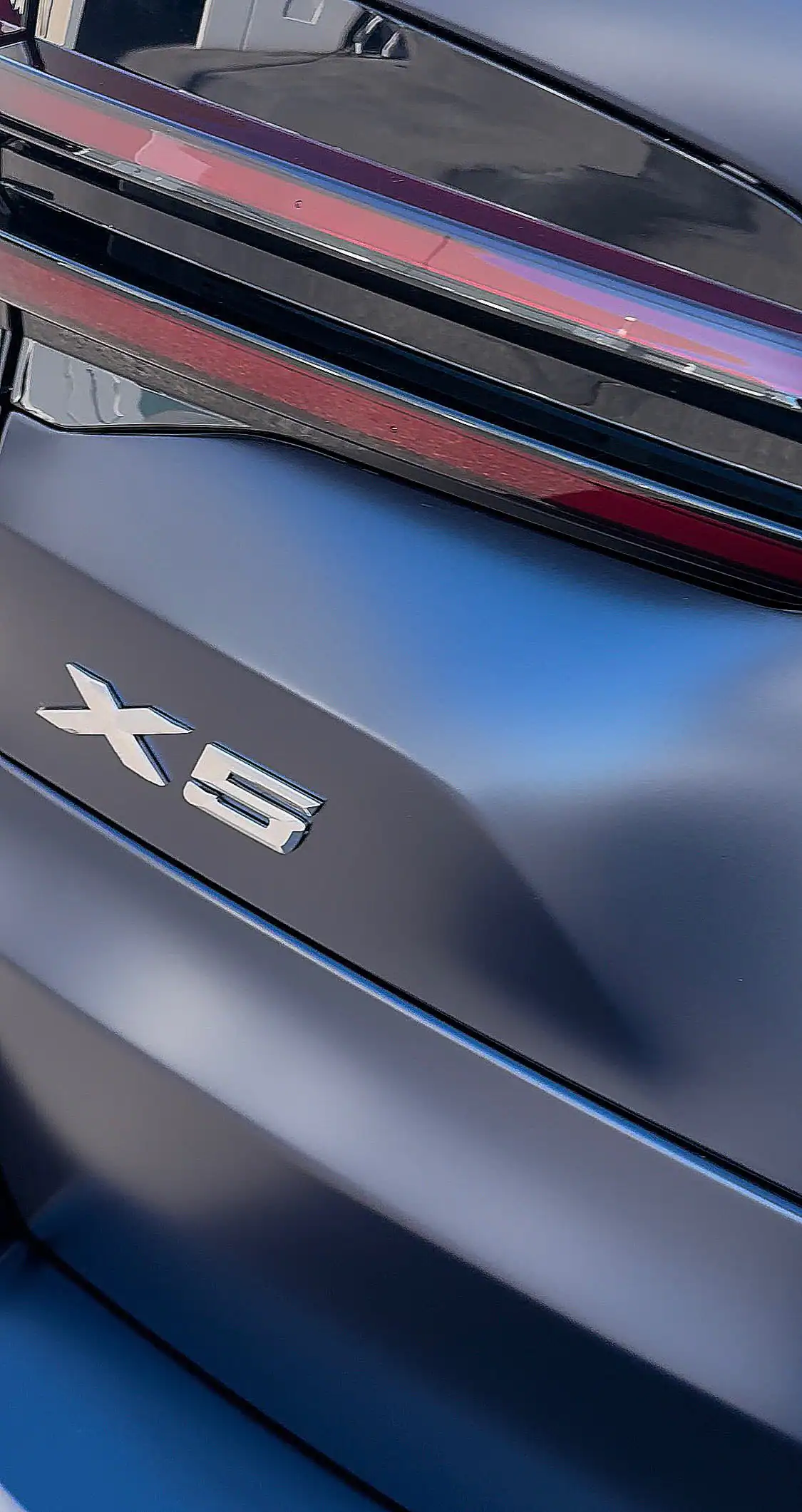 Flat panel on matte BMW X5 showing clean paint protection film installation with no dust or contamination