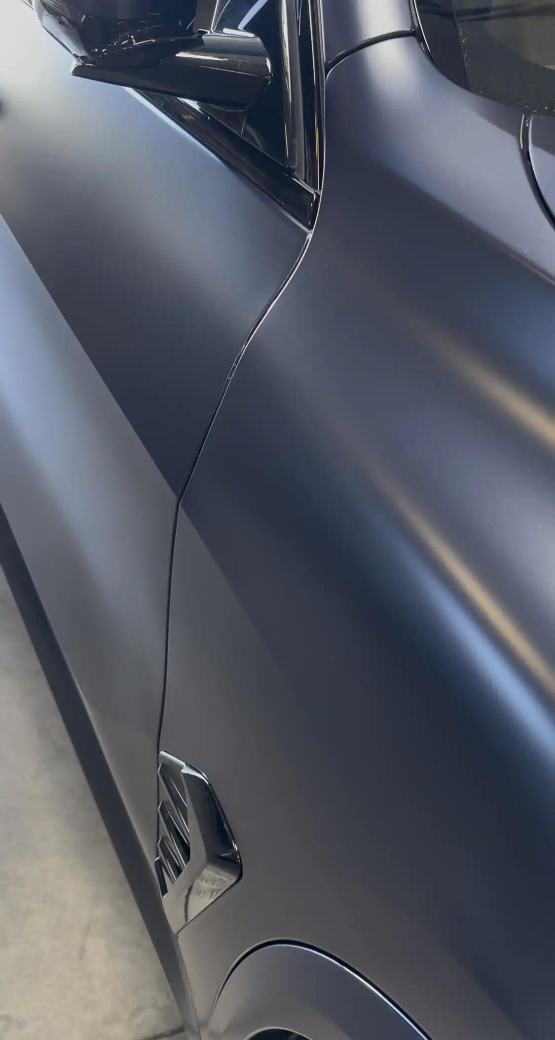Paint protection film seam aligned with body line on matte BMW X5 showing clean professional installation