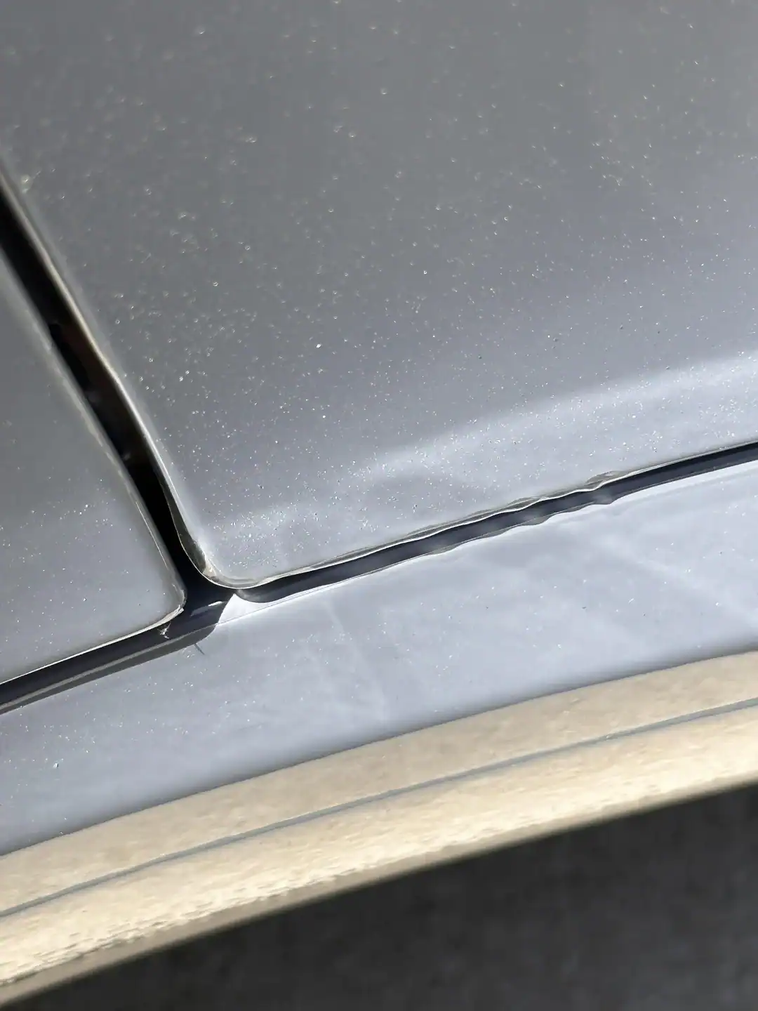 Peeling paint protection film lifting at panel edges due to heat and adhesive failure in Arizona