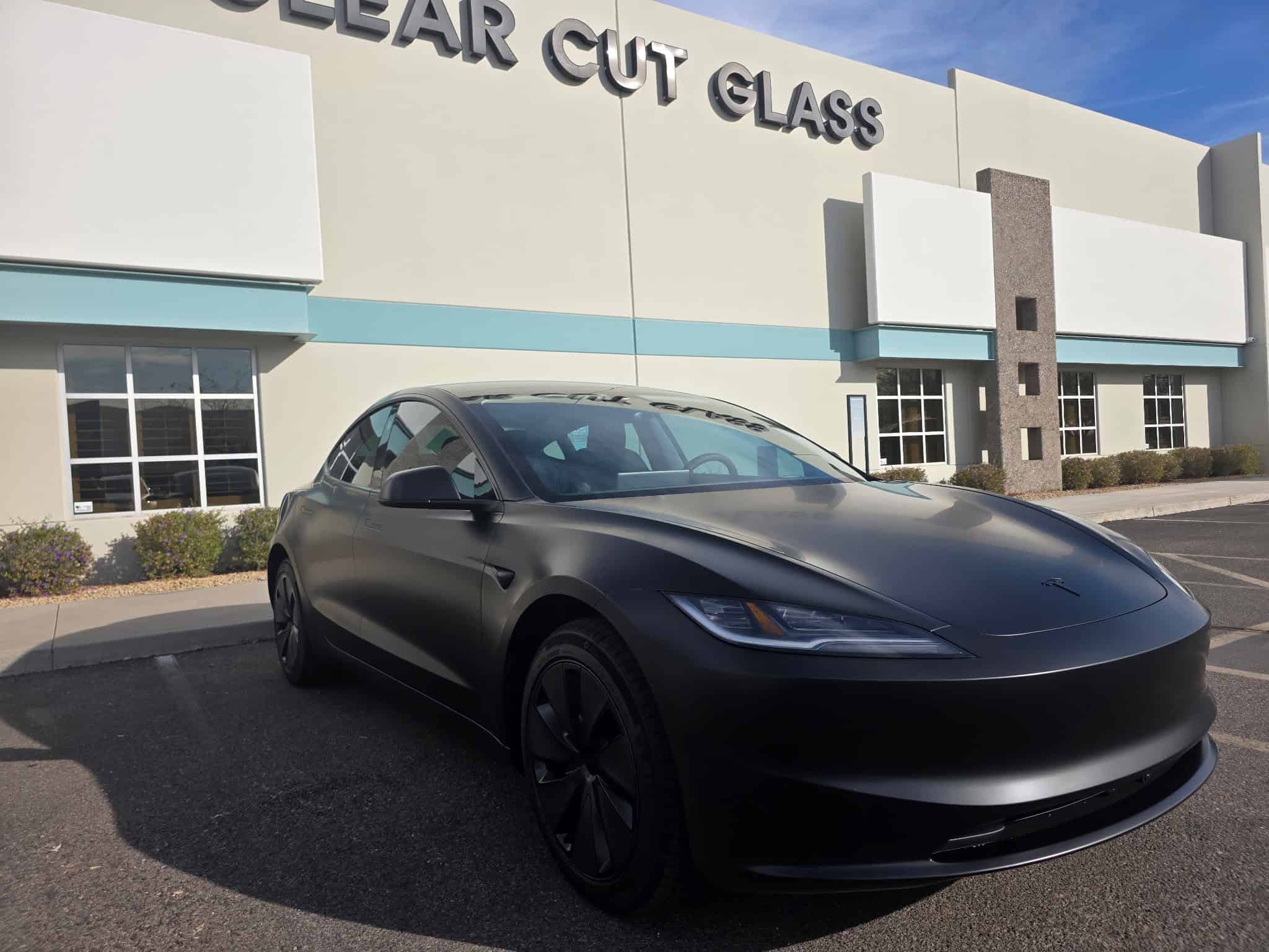 Tesla Model 3 with satin matte paint protection film parked outside Clear Cut Glass and Tint in Glendale Arizona