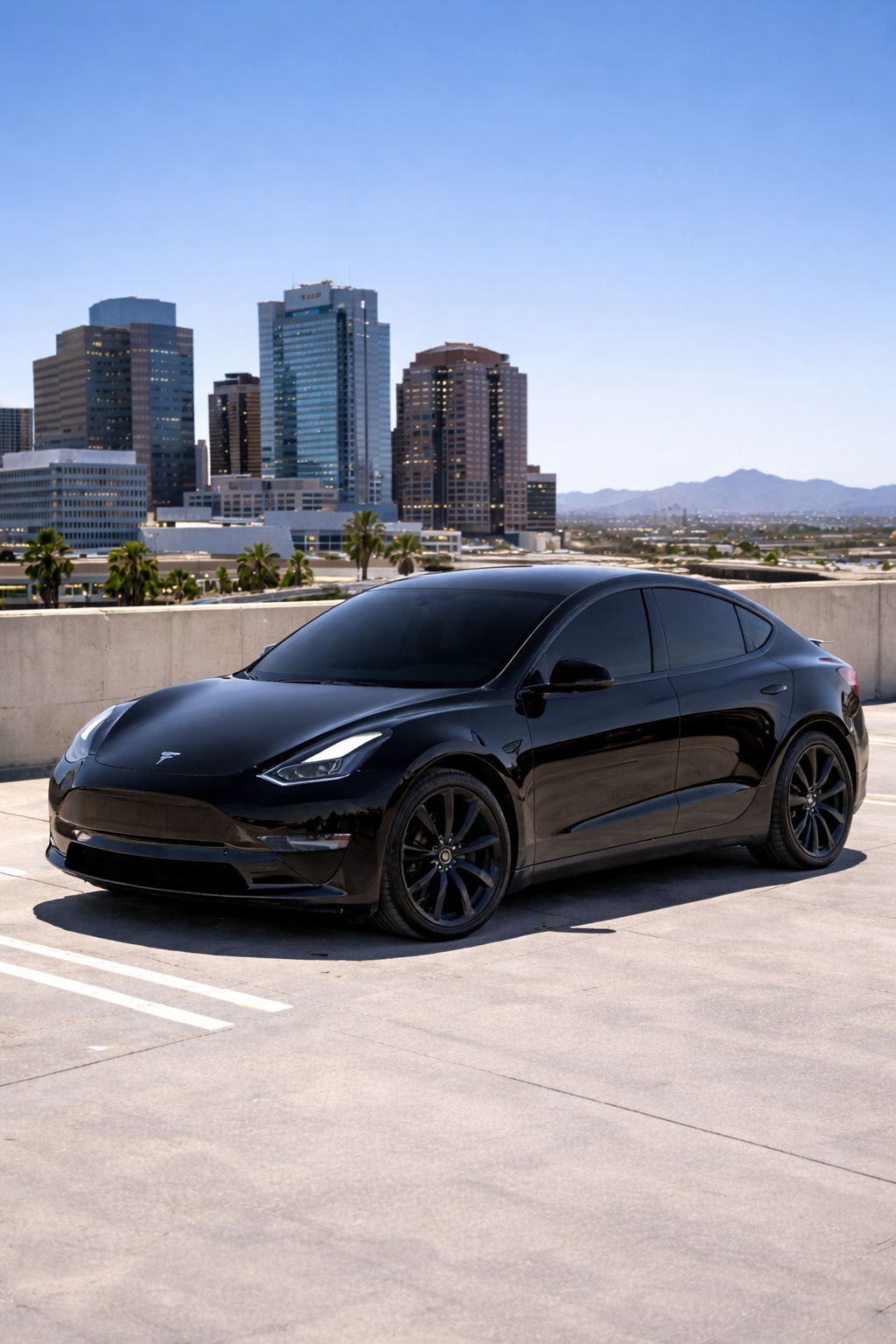 Tesla Model Y with premium ceramic window tint on a downtown Phoenix rooftop in bright midday sun