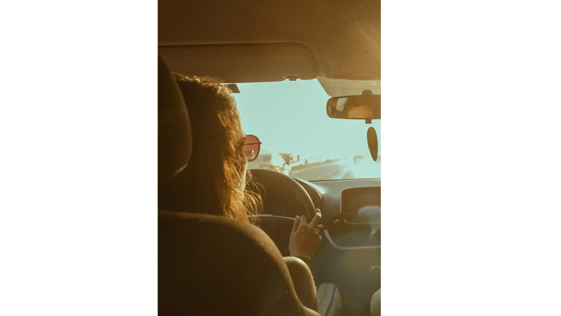 Driver experiencing harsh Arizona sun glare through windshield before windshield tint installation