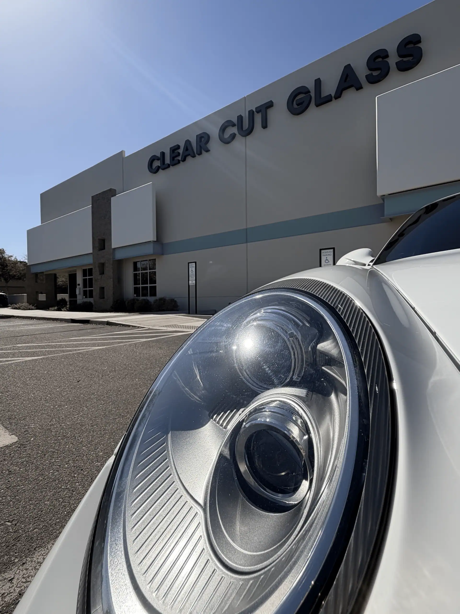 Exterior of Clear Cut Glass & Tint in Arizona with a Porsche sports car parked outside the professional window tint and vehicle protection facility.