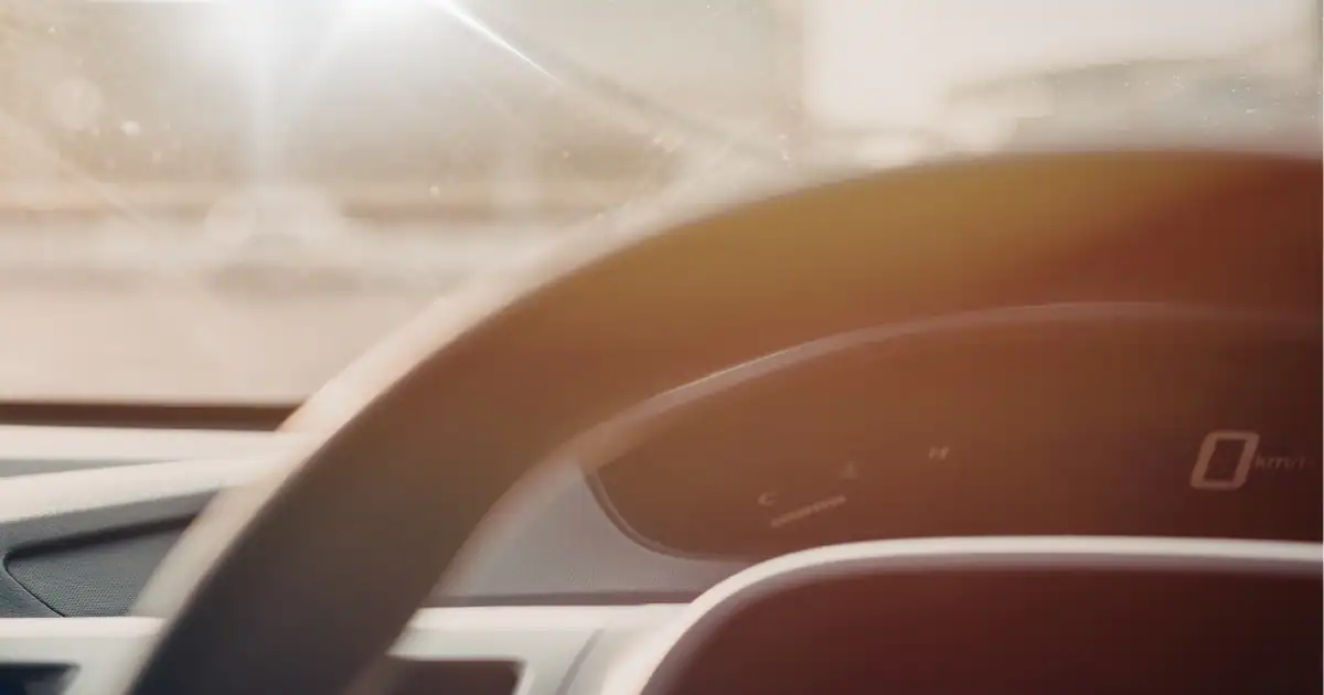 Driver's view of sunlight entering a vehicle, demonstrating the importance of UV-blocking window tint in Arizona