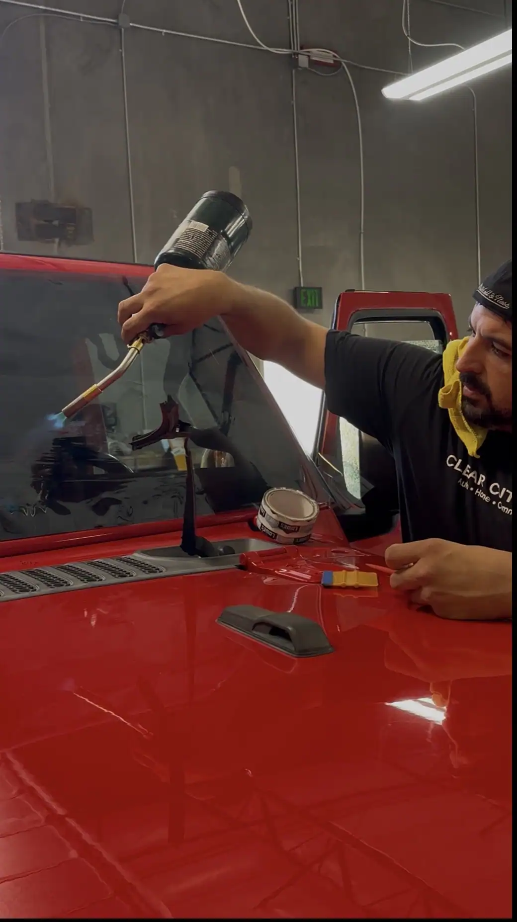 Professional Window Tint Installation Process Window tint technician heat shrinking window film during a professional automotive tint installation at Clear Cut Glass & Tint.